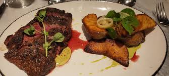 Proudfoot and Bird signature dishes  Wood-Fired Steaks (various cuts), Roasted Oysters, Seafood Towers, seasonal entrees.